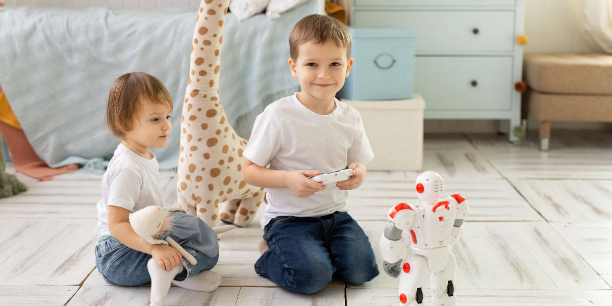 boy and girl sitting on the floor playing with a remote-controlled robot