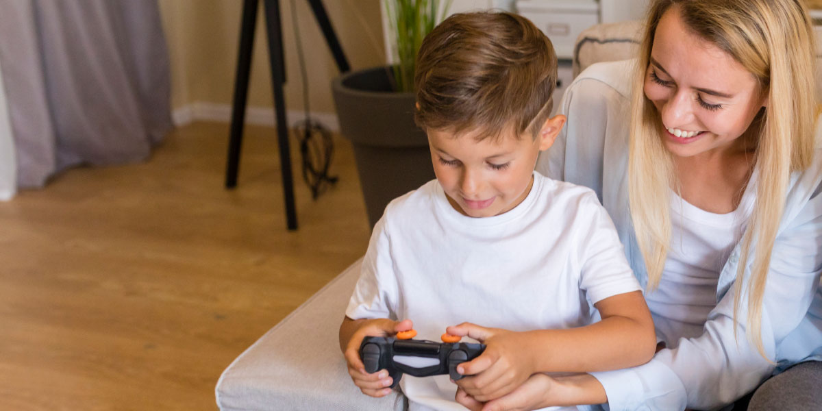 Mother and son playing with a game console