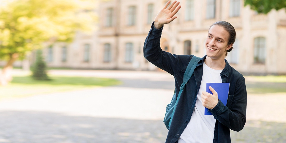 Young man waving goodbye