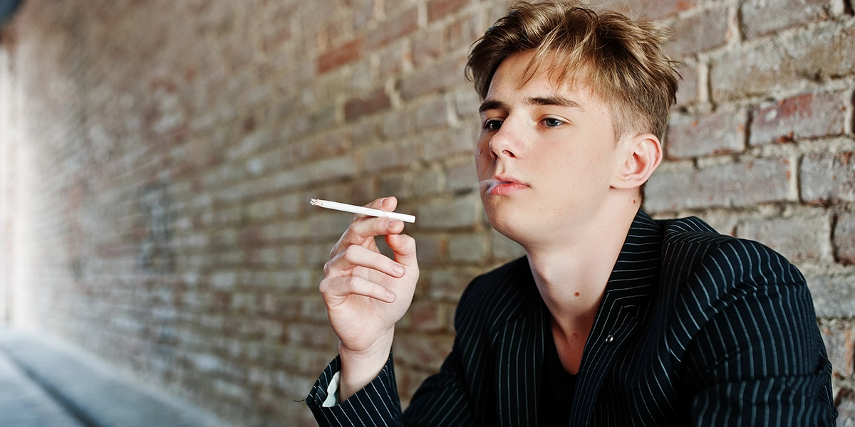 A teenage boy smoking