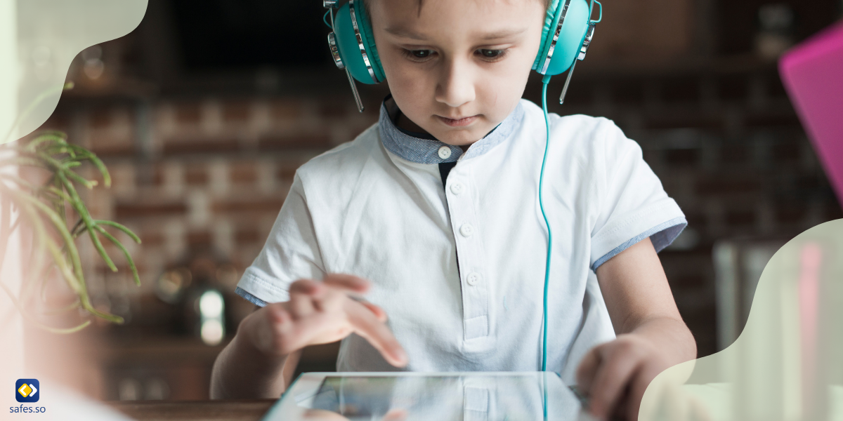 A little boy learning language using his tablet and headphones