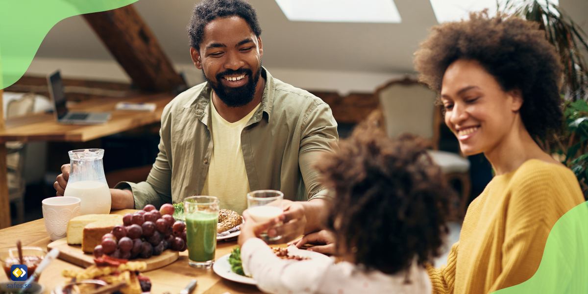 Child eating around the table with her family