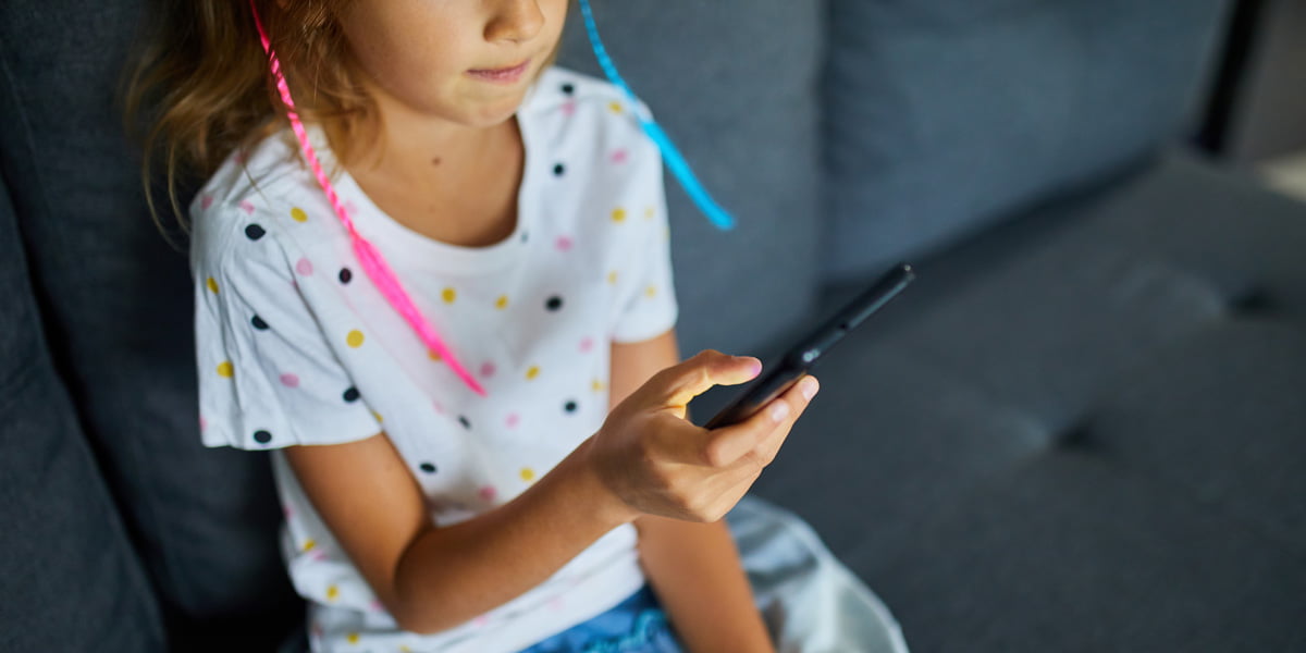 a kid looking at her phone