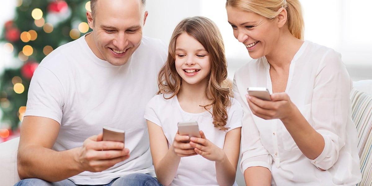 A happy family with cellphones in their hands