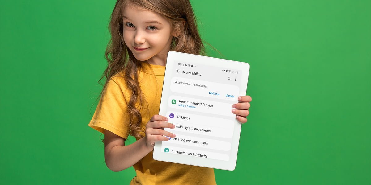 girl with tablet on green studio background.