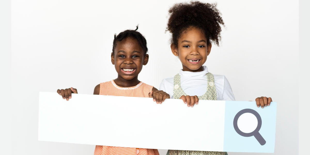 Two little girls holding Google’s search bar in their hands] [NOTE: Please crop the picture horizontally