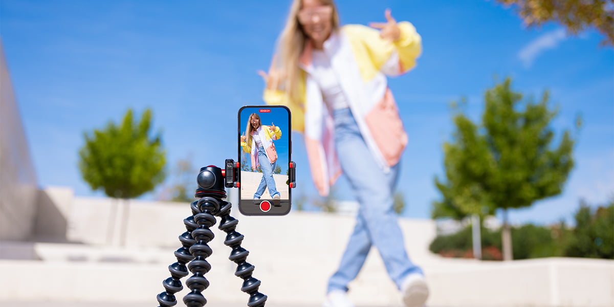 A teenage girl shooting video of herself for Likee in front of a phone