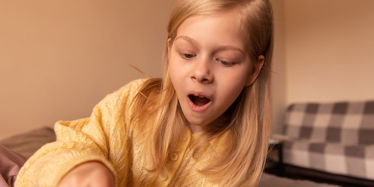 a girl is surprised while playing Clash Royale with her phone