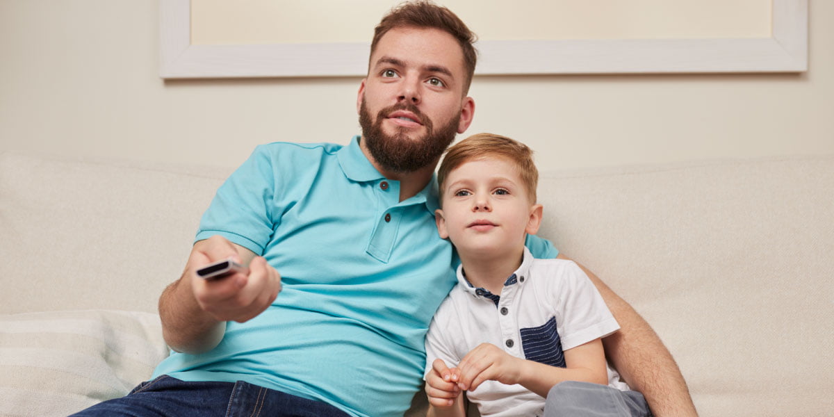 single dad and child watching tv