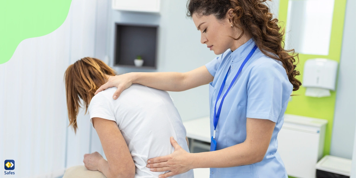 Physiotherapist doing healing treatment on a teenager’s back