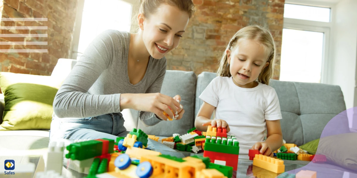 Mother teaching her kindergartener child how to build blocks to prepare her for kindergarten