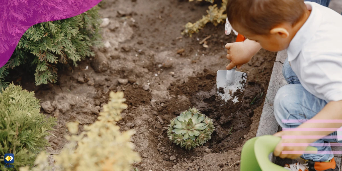 Kindergartener planting a plant in the yard