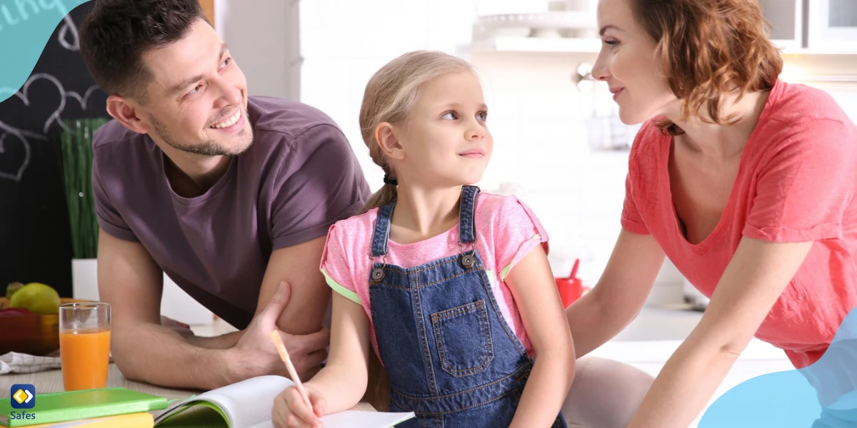 Little girl with parents doing homework at home