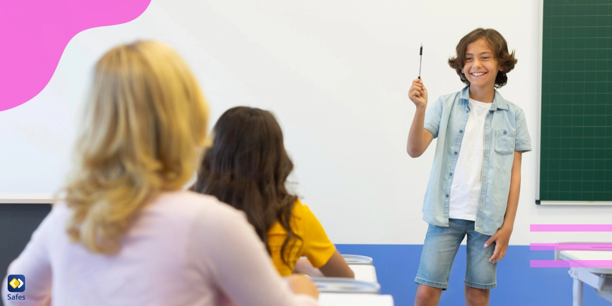 A little boy is presenting in front of his classmates