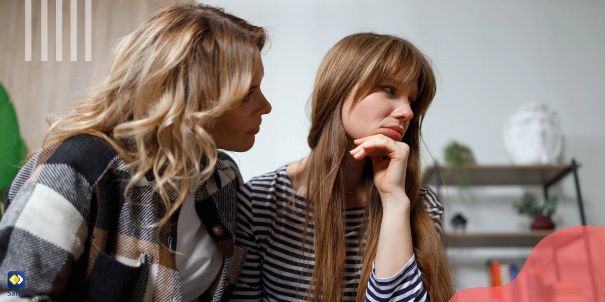 A mother is talking to her upset daughter