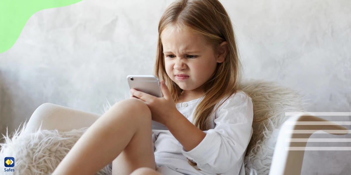 Little girl suffering from fear of missing out while using phone