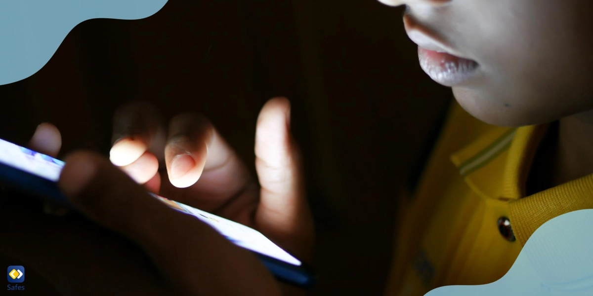 Little boy using phone in the dark to use alt-tech apps