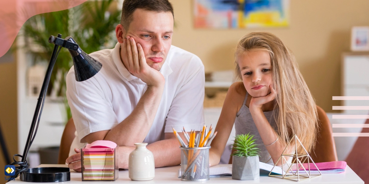 Vater und Tochter blasen Trübsal auf einem Schreibtisch