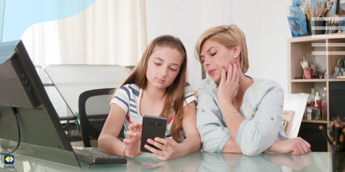 Mother and daughter looking at a phone