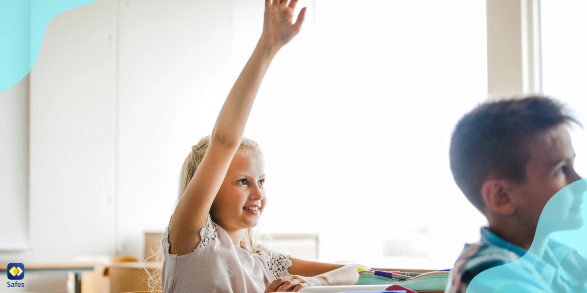 Student raising her hand to participate in the class because she is motivated to learn more