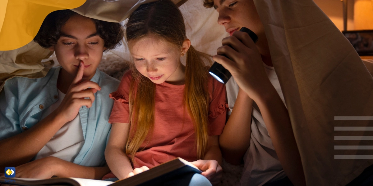 Children reading spooky stories in low light