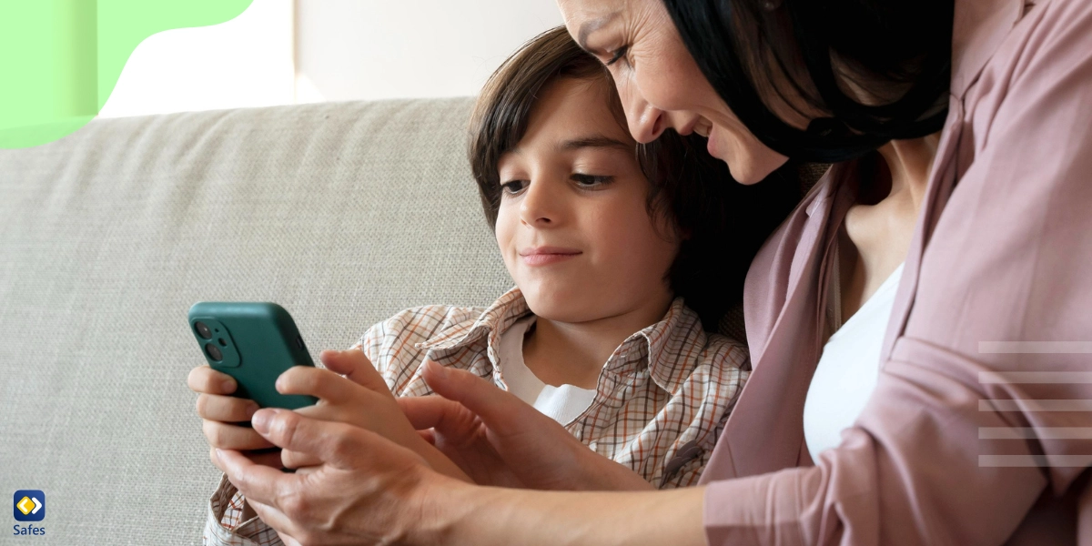 Mother and son looking at protected phone