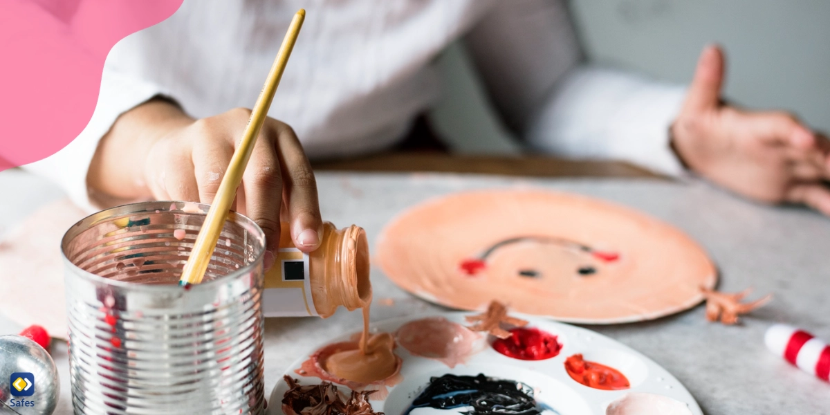 Child mixing paint to paint on a plate