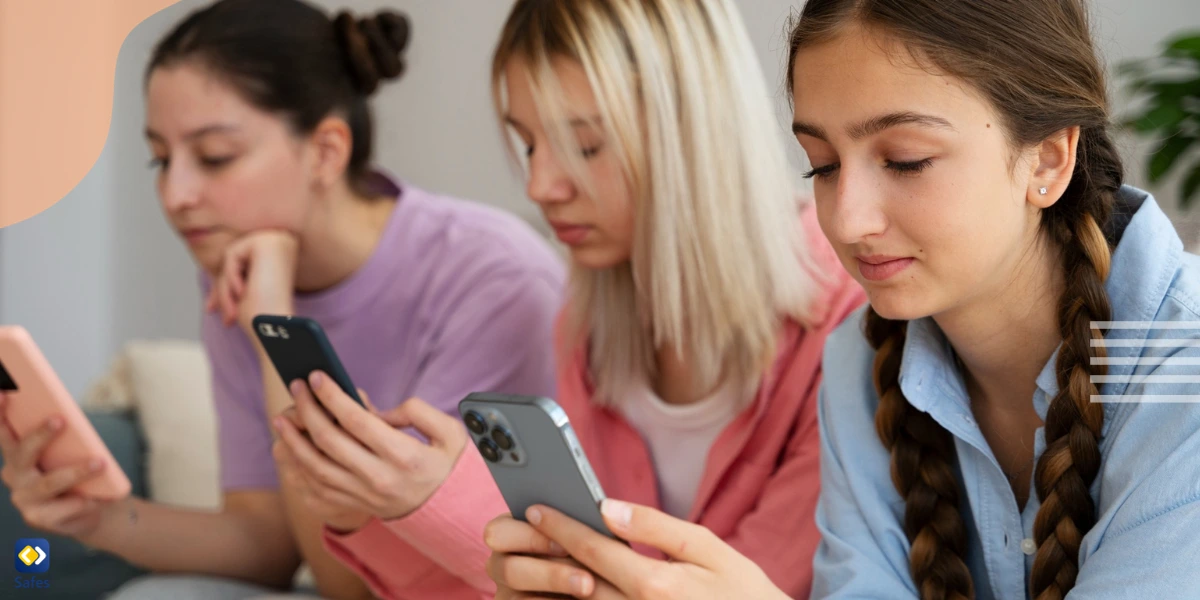 Three teenage girls texting on their smartphones.