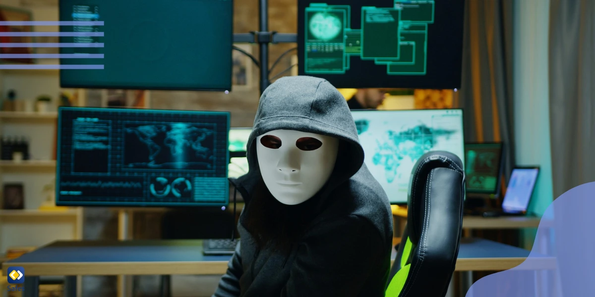 Image of a hacker in front of televisions