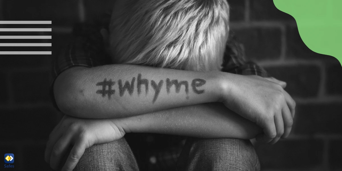 Little boy holding his head in his arms with “#whyme” written on his arm