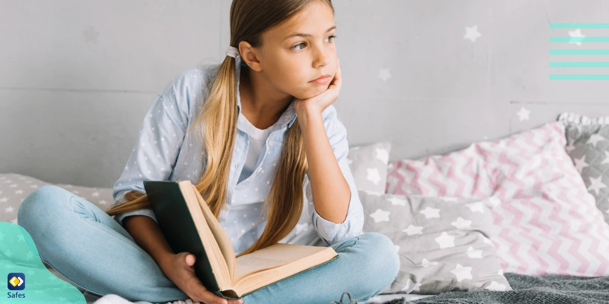 A young girl deep in thought about the characters of a book she’s reading