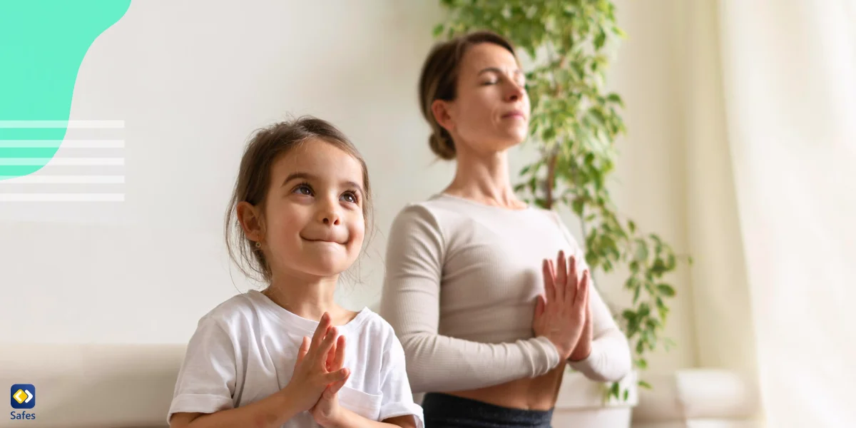 a mother practicing meditation with her young daughter