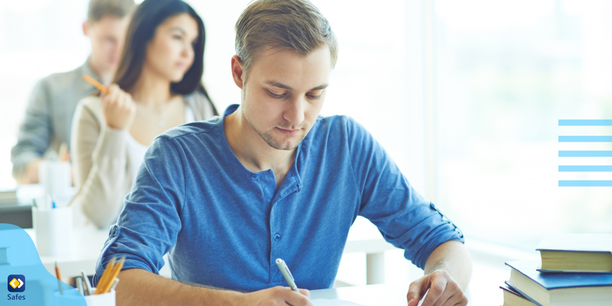 a young guy taking the SAT in a classroom