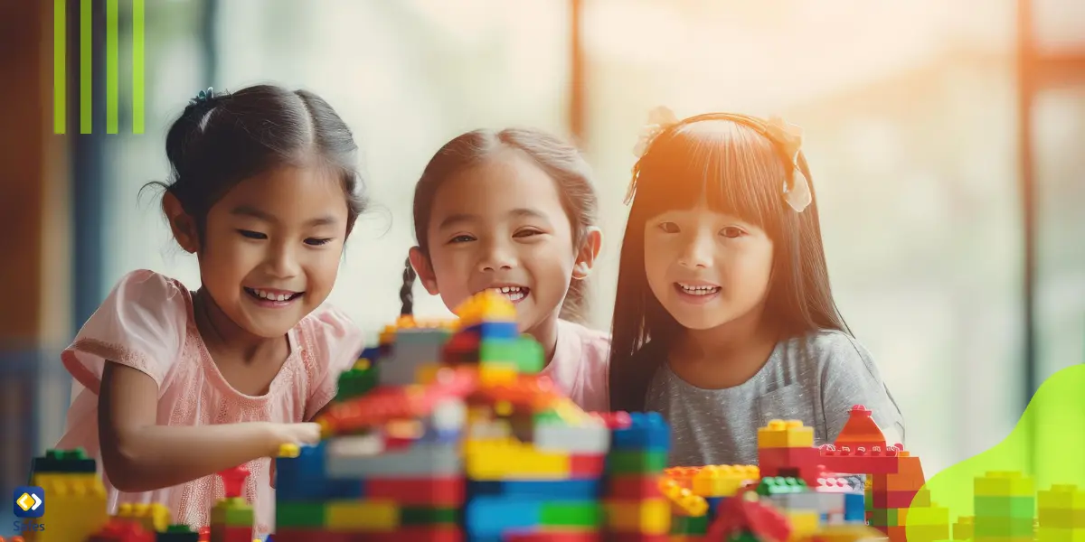 Three kids engaged in creative play with colorful building blocks indoors