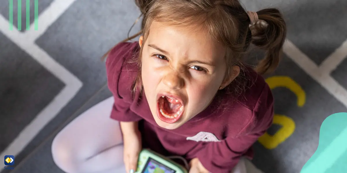 A girl throwing a tantrum because she can no longer play her video game.