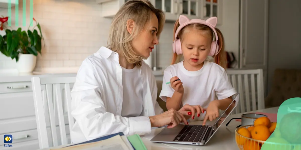 a mother showing her daughter something on a laptop and helping her to use digital devices safely.