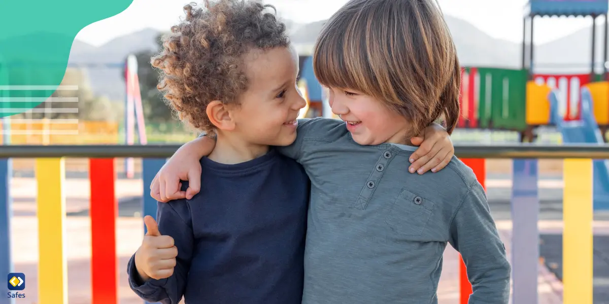 two young boys putting their hands around each other's necks and smiling at each other