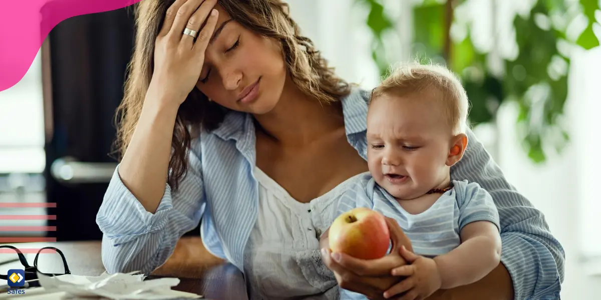 a mother is holding her baby and giving him an apple while keeping her hand on her forehead, feeling so exhausted and overwhelmed