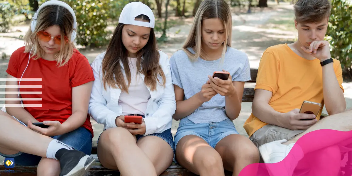 several teens sitting on a bench and exploring social media using their phones