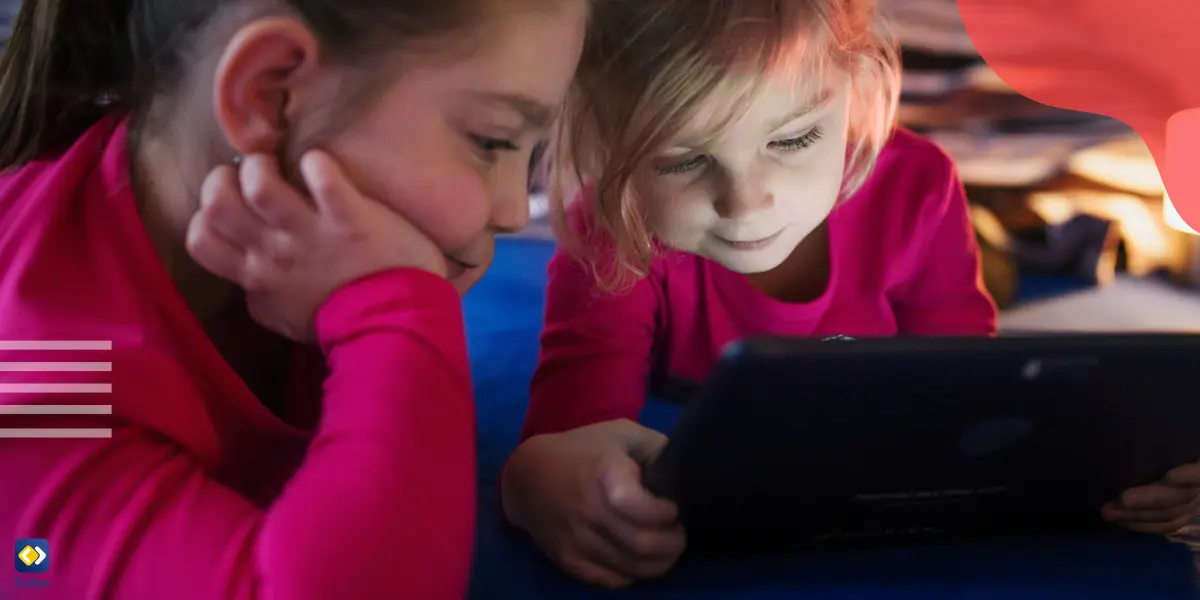 two young girls looking at a device’s screen and using the Noplace app