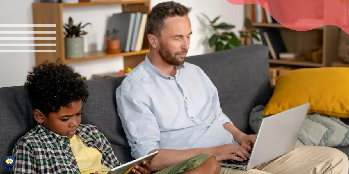 A father and son sitting on a couch, both using electronic devices.