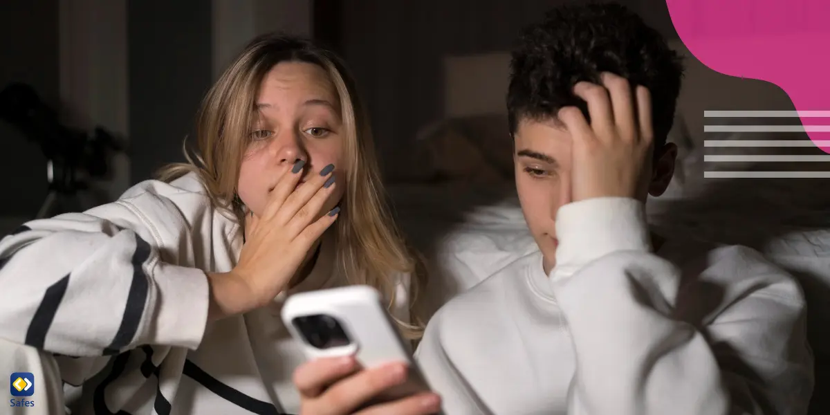 a teen boy is checking his Facebook profile that has been fraped and a teen girl is next to him, both being shocked