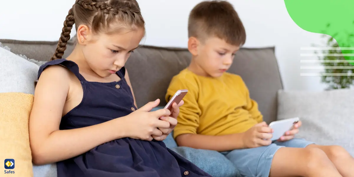 A young girl and a boy are playing with their phones, staring at the screens