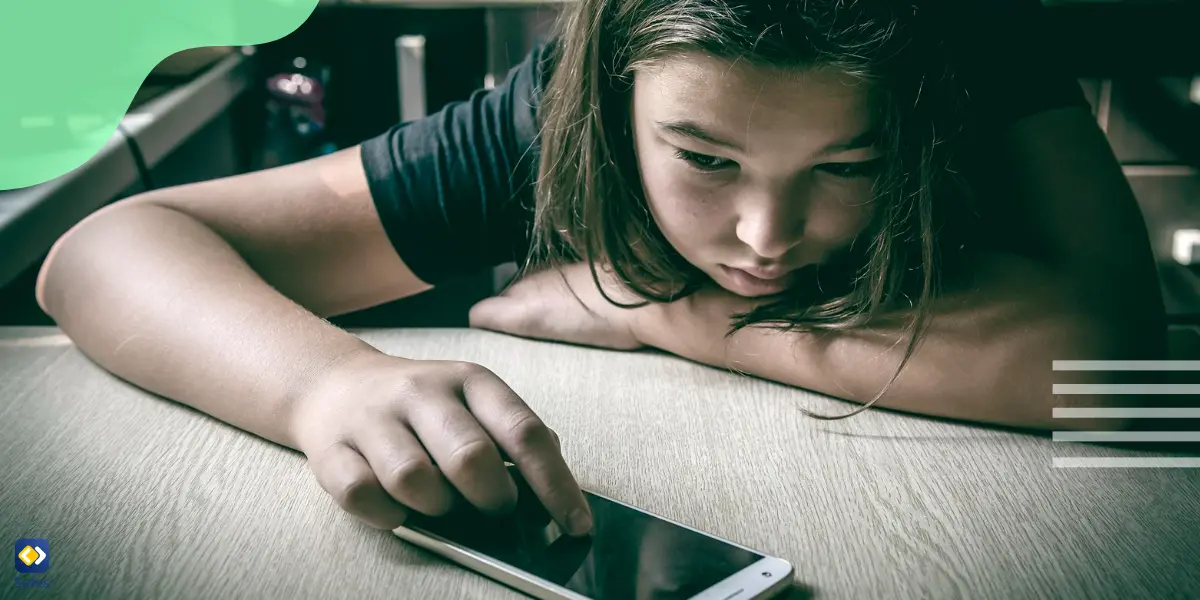 a young girl using her phone and upset about text message bullying