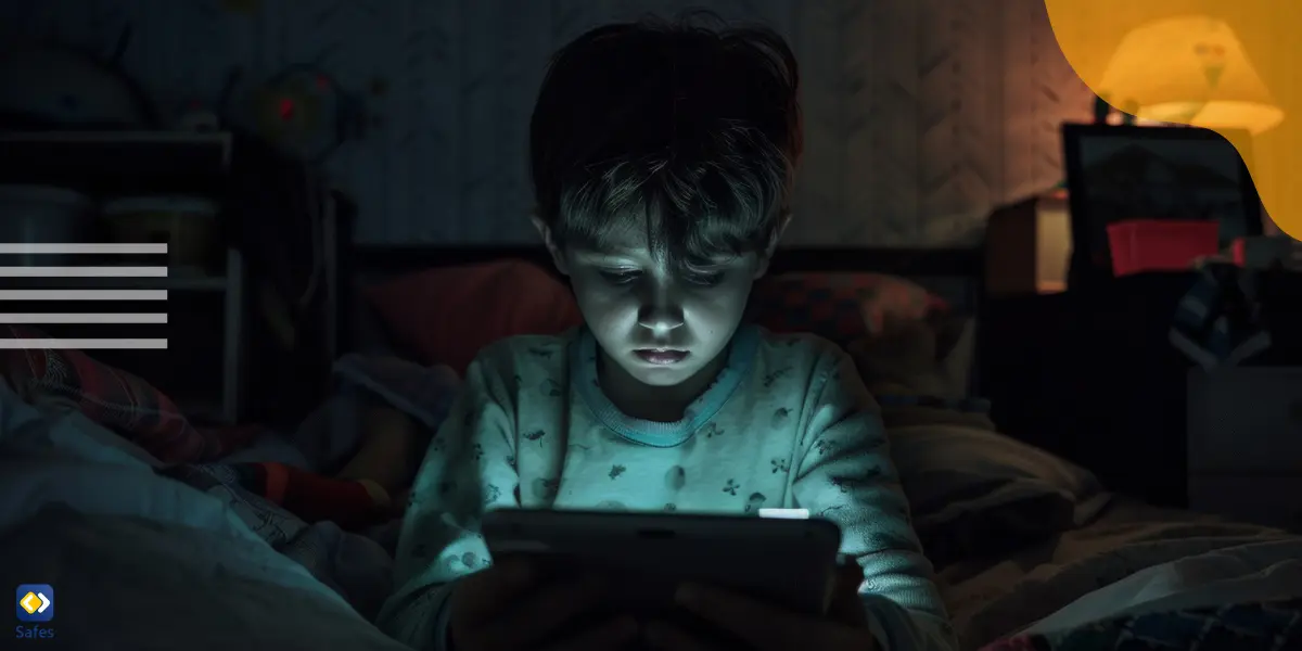 a young boy watching porn on his tablet at night