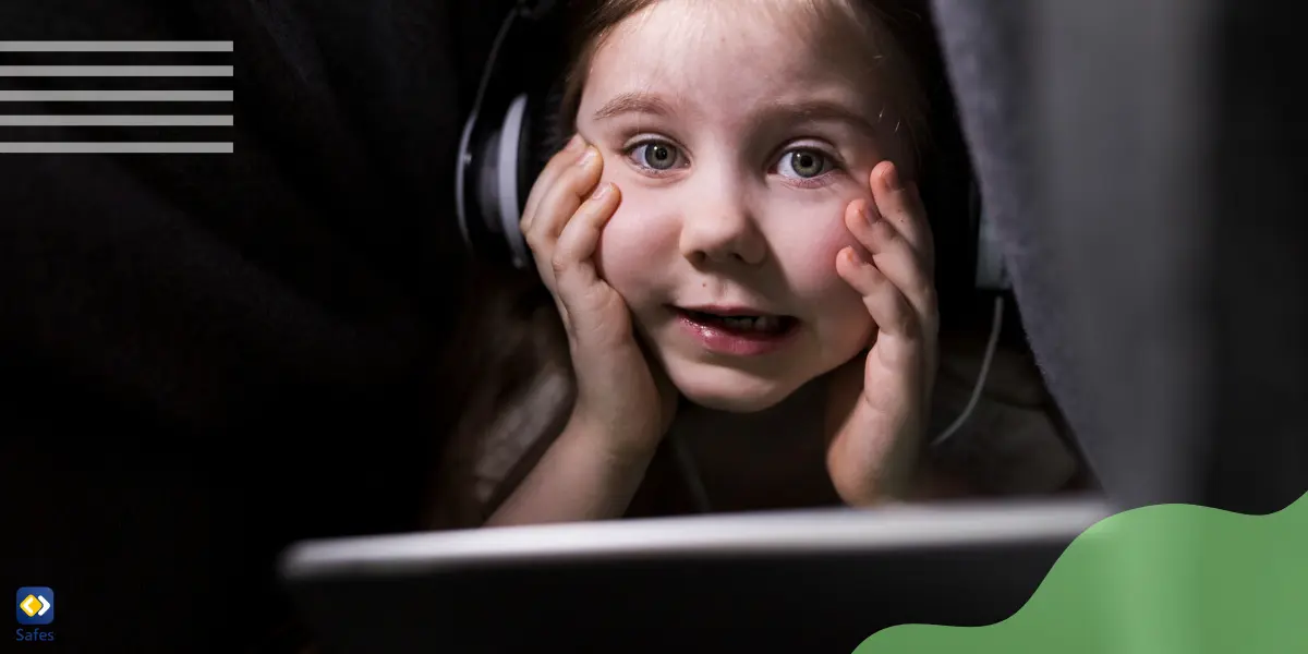 A young child is using a tablet while sitting under a blanket, alone and vulnerable to online predators.