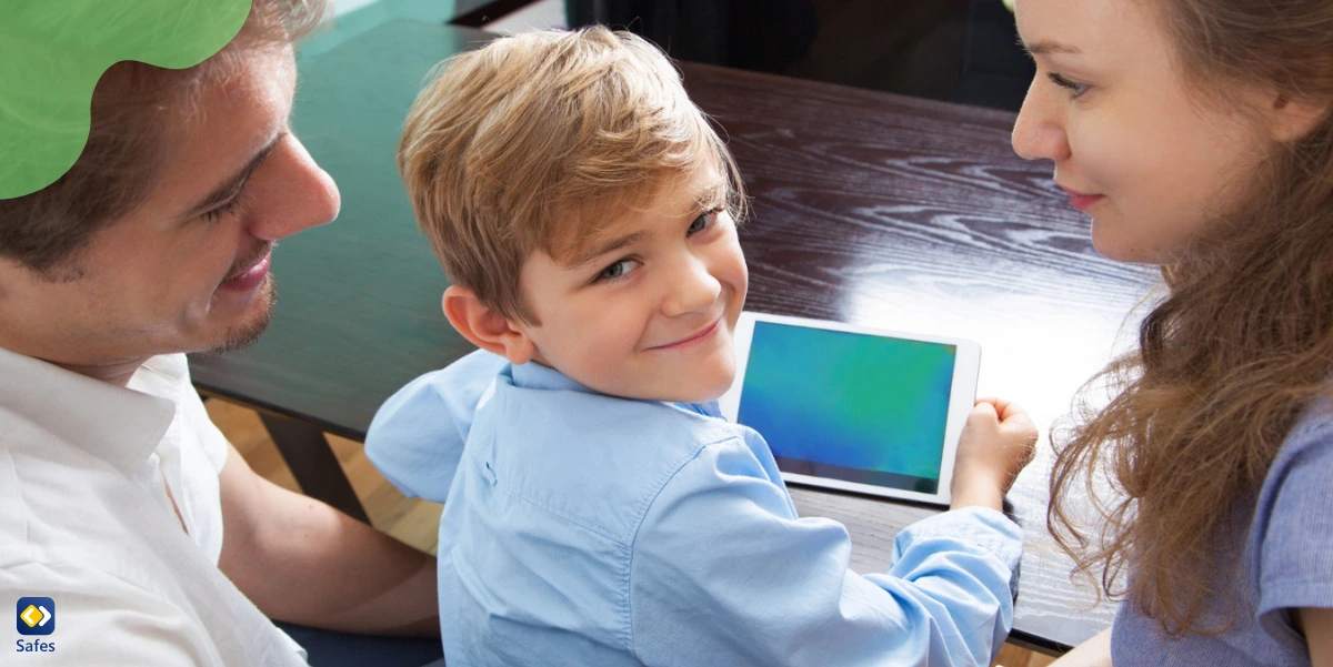 a boy is using his tablet with his parents beside him