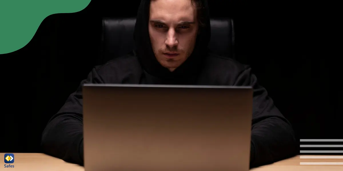 An online predator is typing on a laptop, keeping his anonymity.