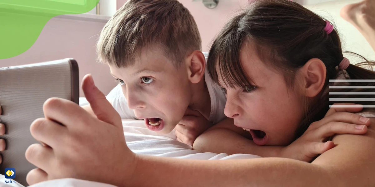 Aboy and a girl are screaming and looking in surprise at the digital tablet