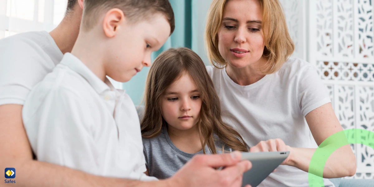 Parents setting up parental controls on their children’s tablet and talking about it.